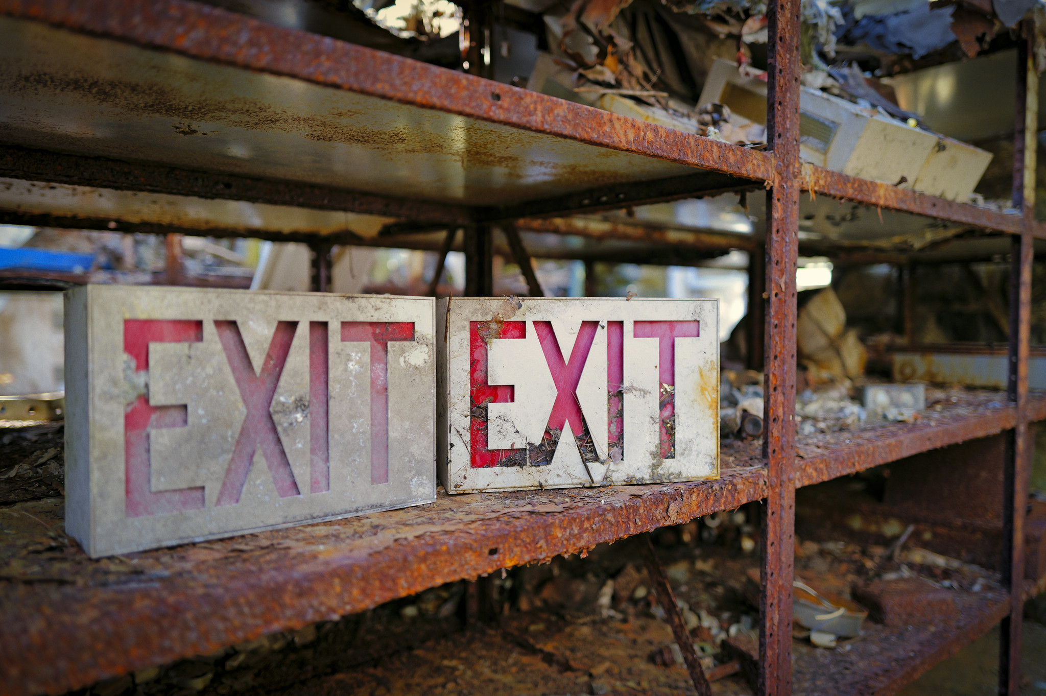 A Rusting Metal Shelf Holding Abandoned Exit Signs