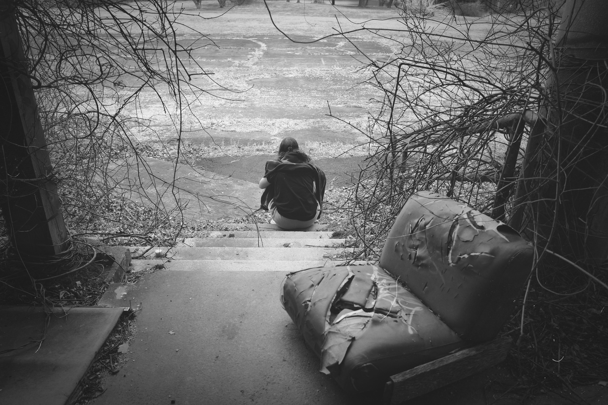 A Young Woman Waits Outside On The Steps Of A Building